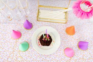 birthday cake and party hats flat lay
