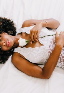 Styled boudoir photography with natural hair African American woman wearing handcrafted aquamarine earrings and sparkly bridal bracelet by J'Adorn Designs fine art jewelry