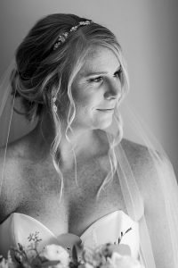 Bridal portrait featuring blonde woman in sparkly gold bridal teardrop earrings by J'Adorn Designs bridal jeweler for a classic Annapolis wedding at Chesapeake Bay Beach Club