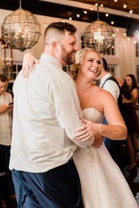 Bride and groom dancing at their wedding, bride wears sparkly gold bridal teardrop earrings by J'Adorn Designs bridal jeweler for a classic Annapolis wedding at Chesapeake Bay Beach Club