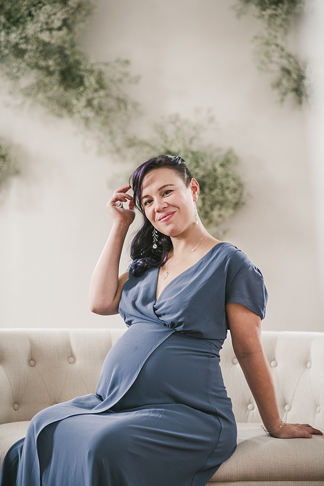 Maternity portrait of a mother-to-be wearing a slate grey gown and silver aquamarine jewelry to match. Handcrafted jewelry for a maternity photo session by J'Adorn Designs