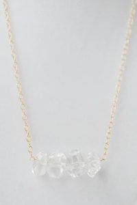 Modern neutral necklace from Betsy's Mother's Day gift wishlist: Crystal quartz bar necklace featuring four geometric crystal quartz beads on a delicate gold chain